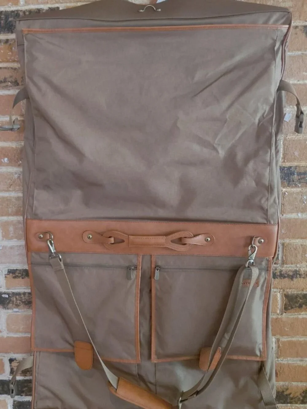 Features 2 deep front pockets with exterior/ interior zipper compartments galore